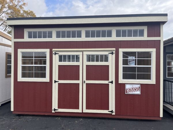 Modern shed red with white trim. Two windows, one on each side