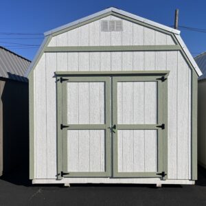 White with green trim lofted shed