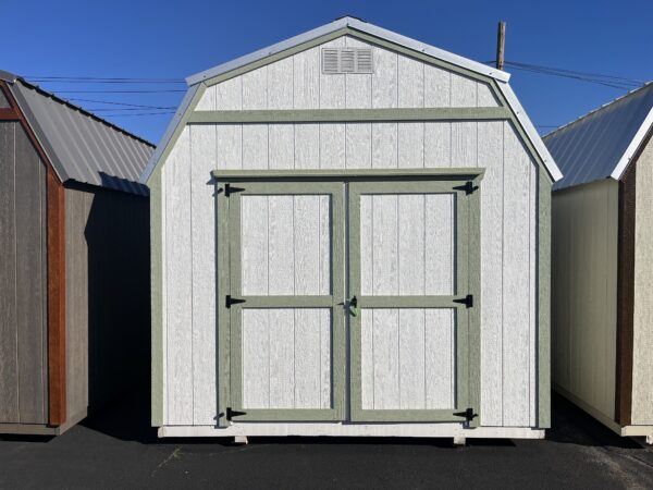 White with green trim lofted shed