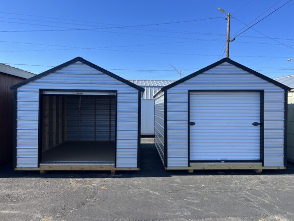 Two 10 x 12 Metal Buildings sitting side by side. One with the roll up door open and one with the door closed.